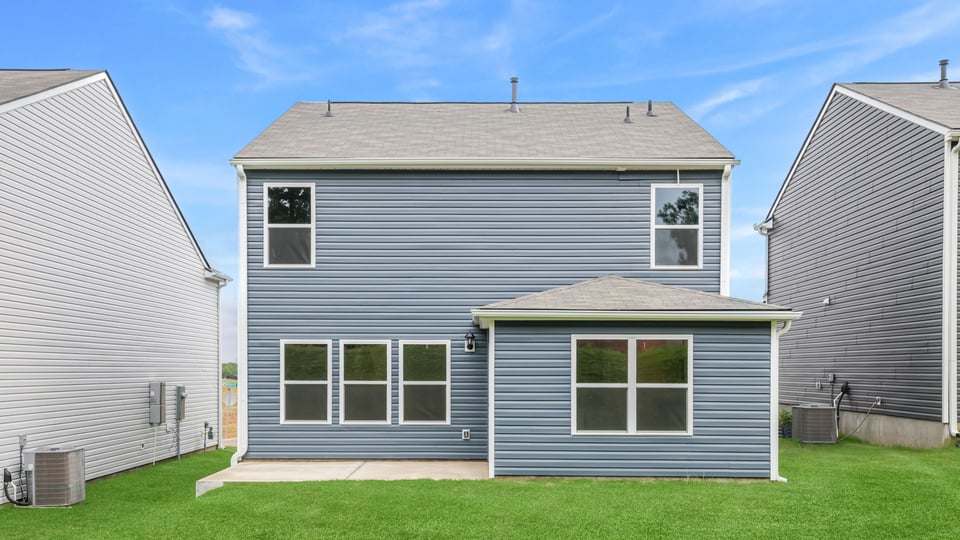 Back exterior with large backyard.