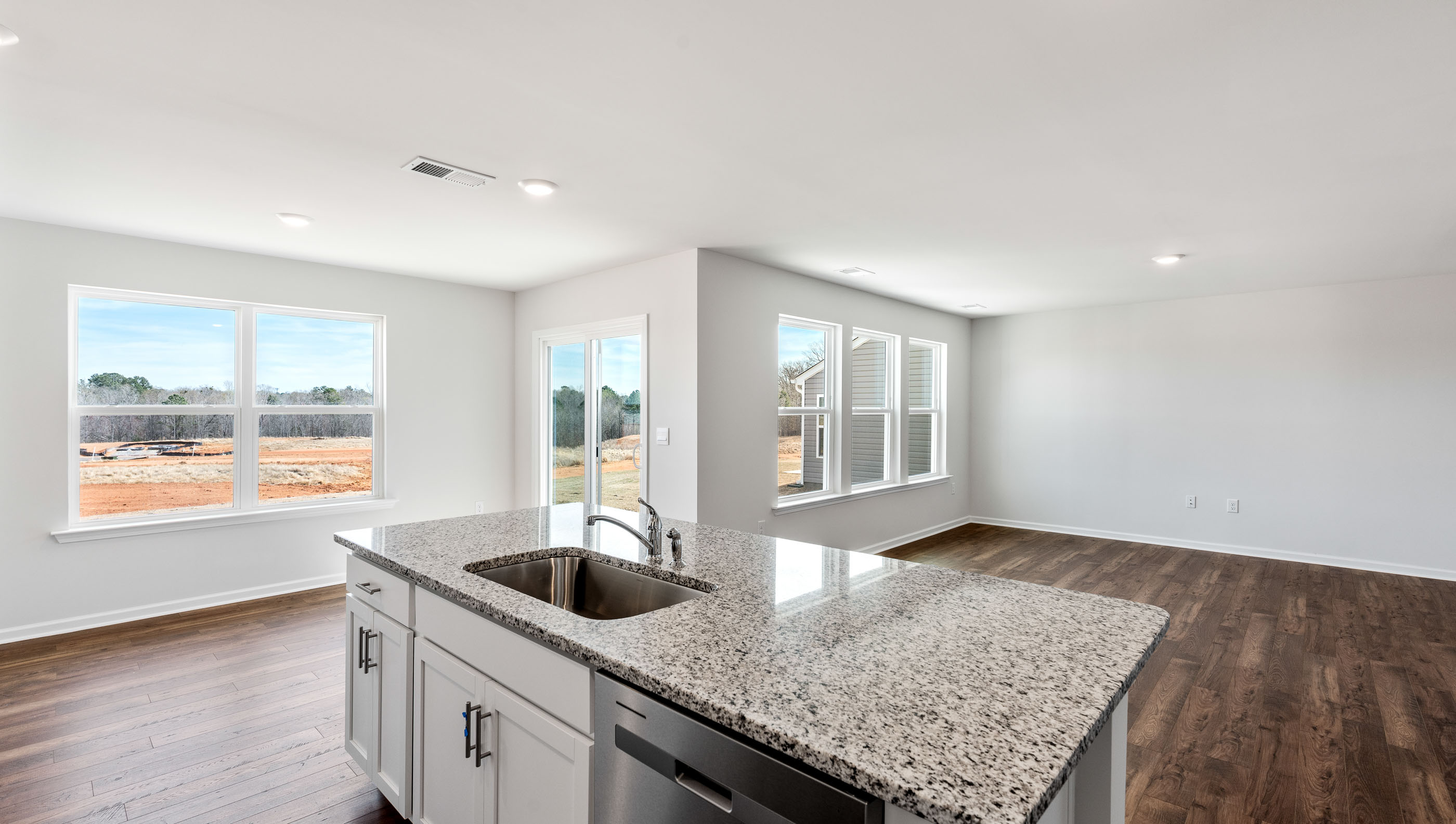 Kitchen and island with granite counter tops.