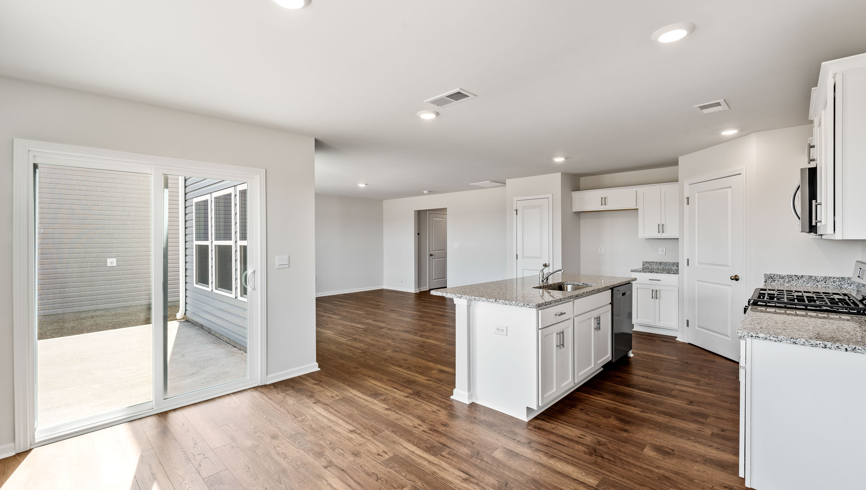 Kitchen and island with granite counter tops.