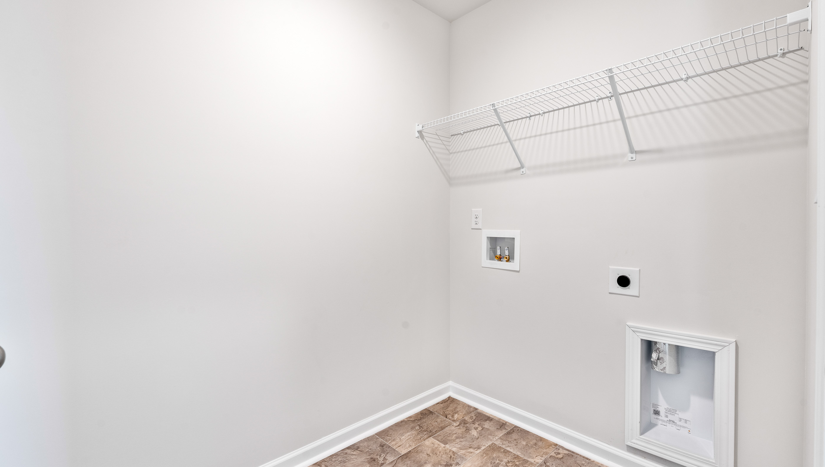 Laundry room with hanging storage racks.