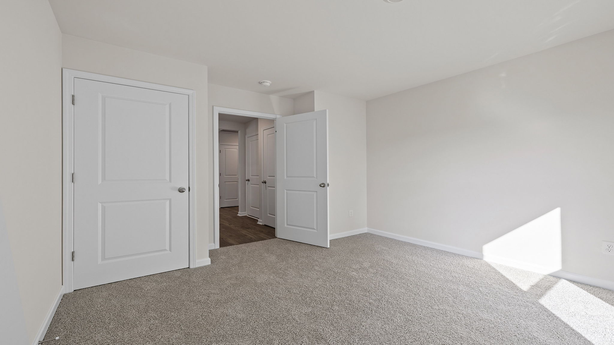 Bedroom with window and carpet.