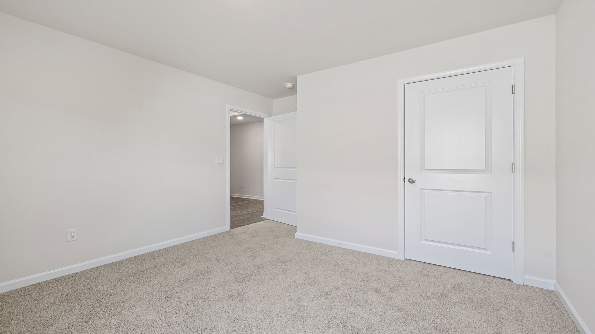 Bedroom with window and carpet.