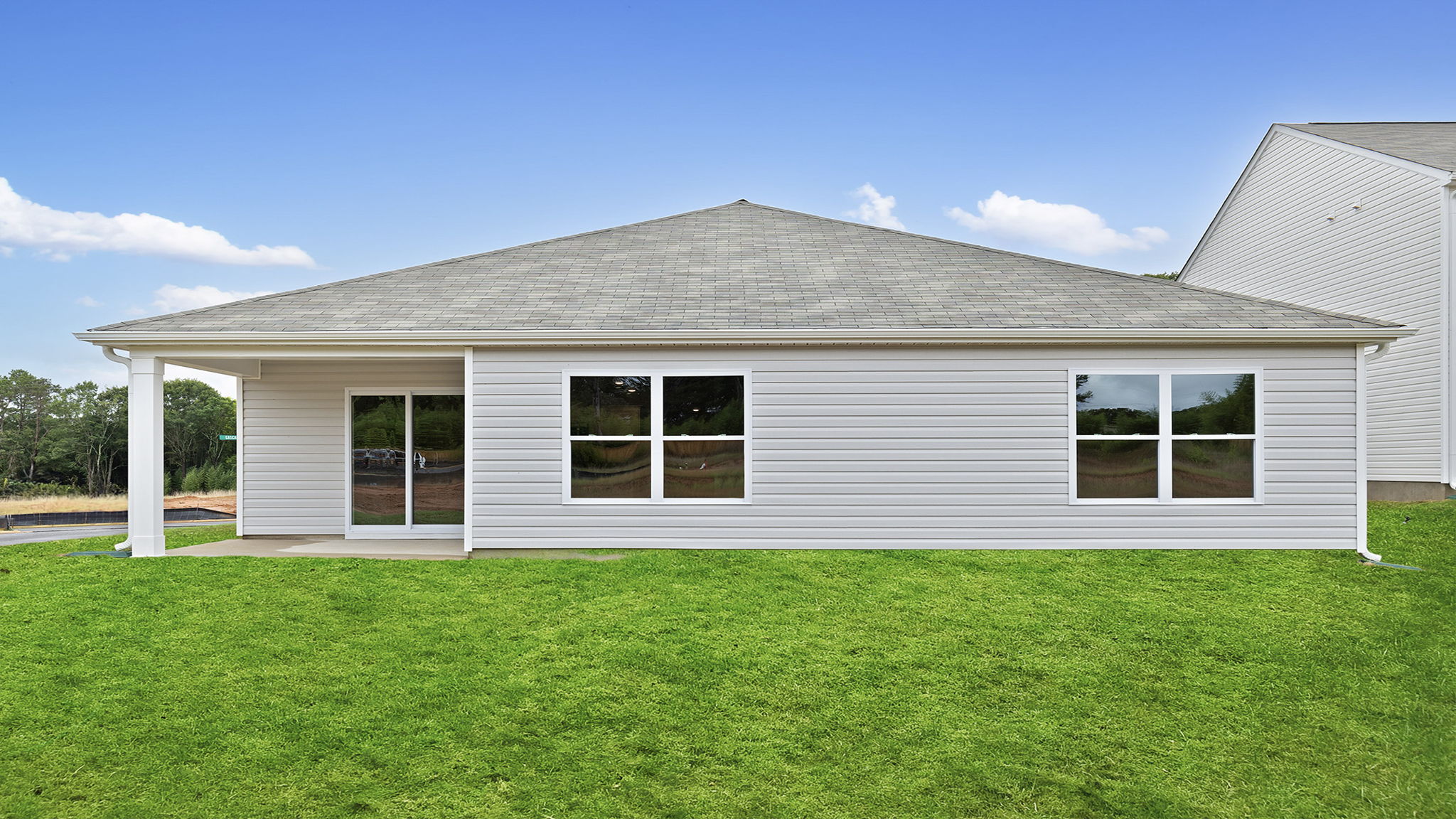 Back exterior with covered porch.