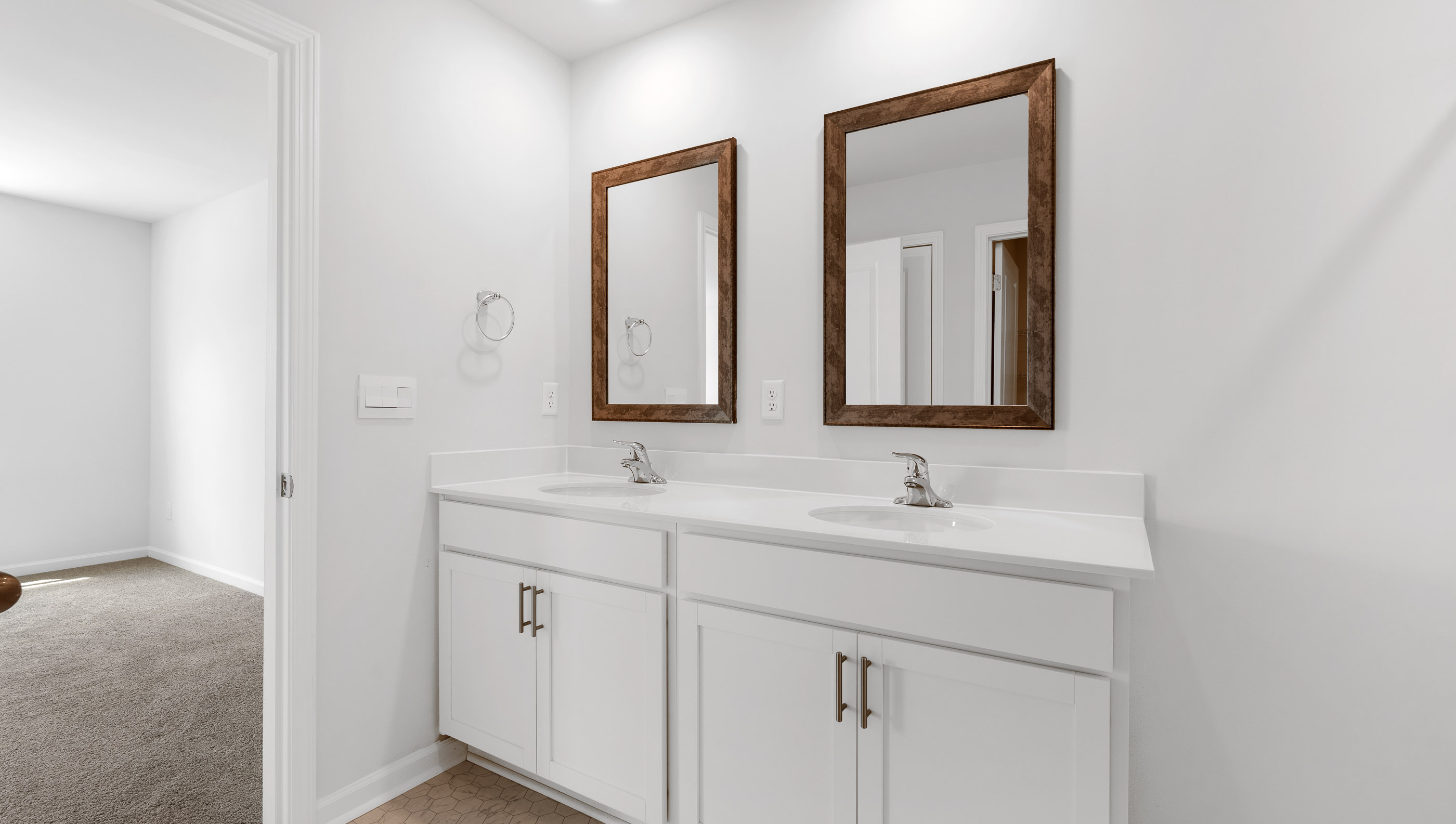 Bathroom with double vanity sink and shower.