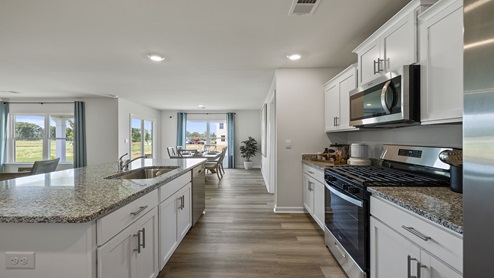 Kitchen with island and cabinets.