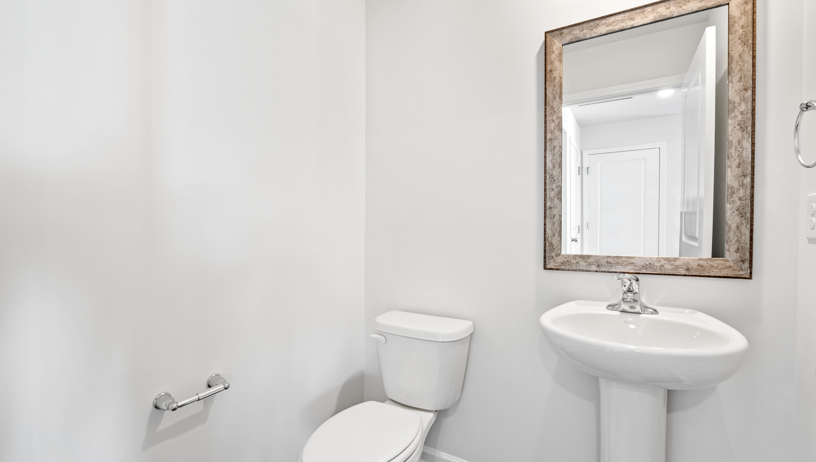 Half bathroom with mirror.