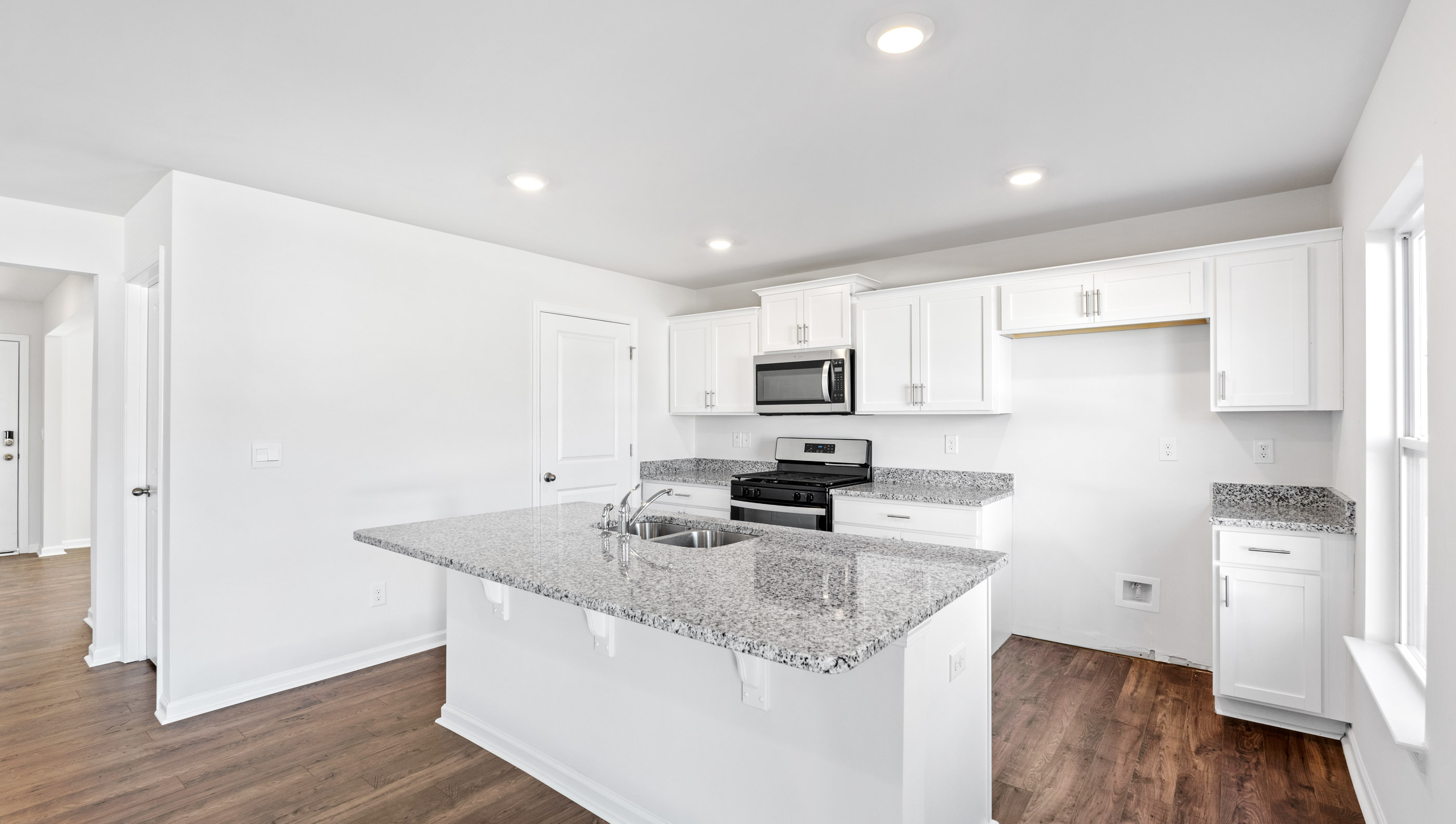 Kitchen and island with granite counter tops.
