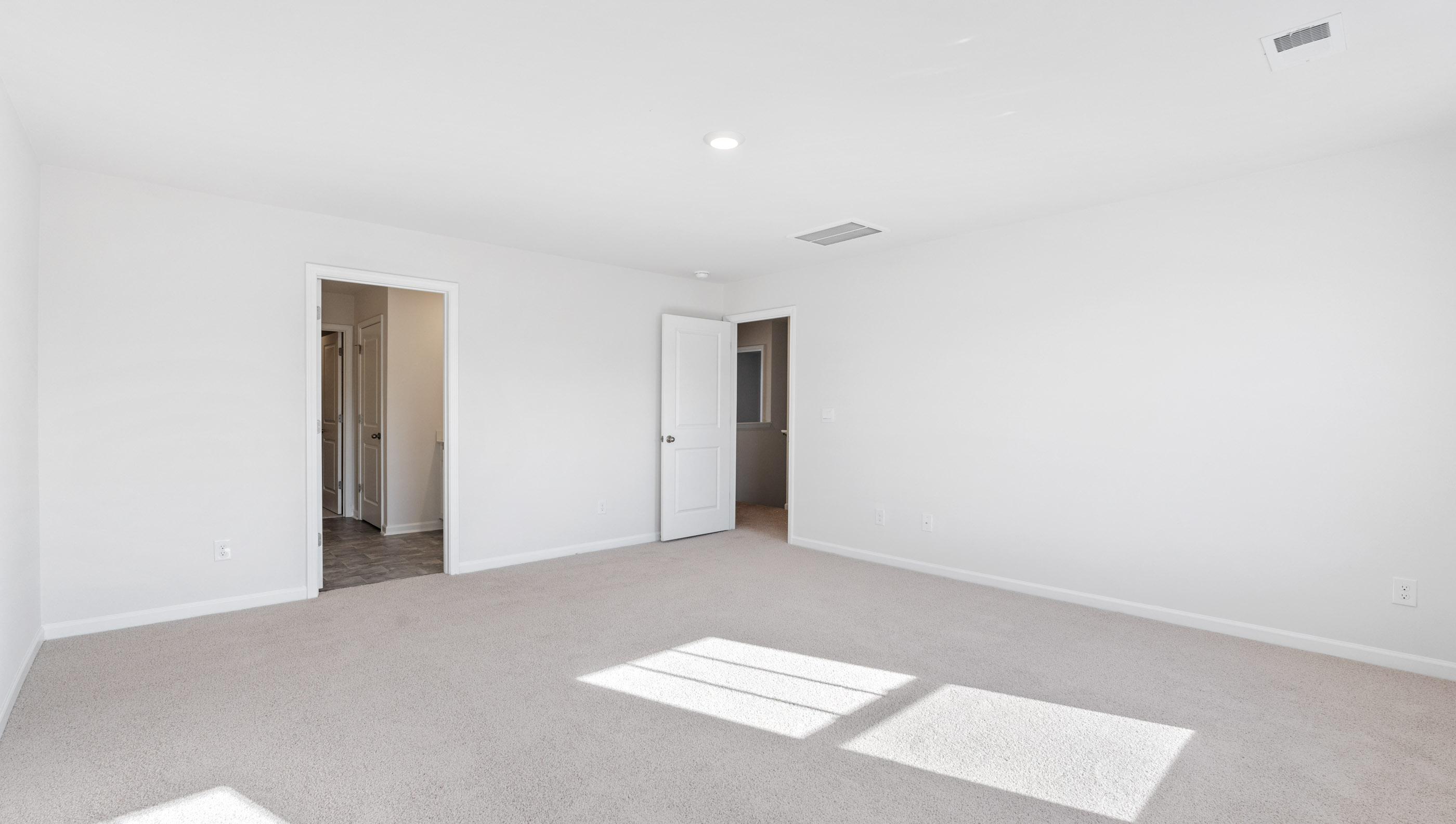 Bedroom with carpet and window.