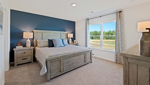 Bedroom with carpet and window.