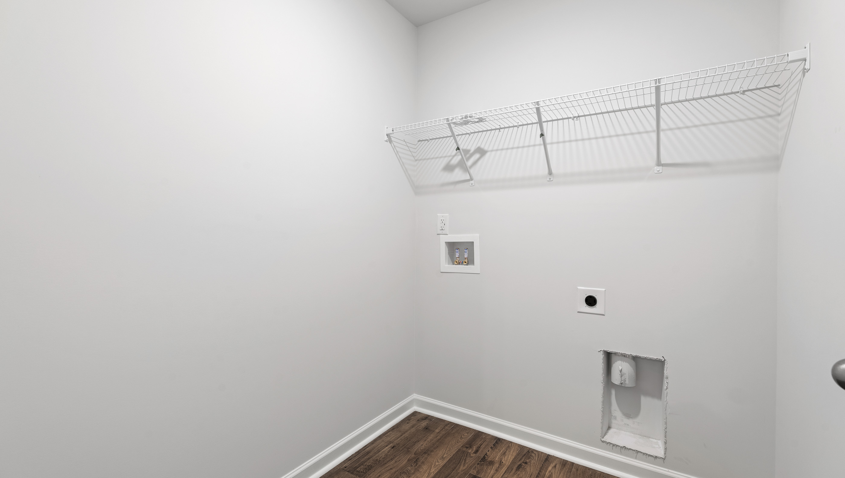 Laundry room with shelf.