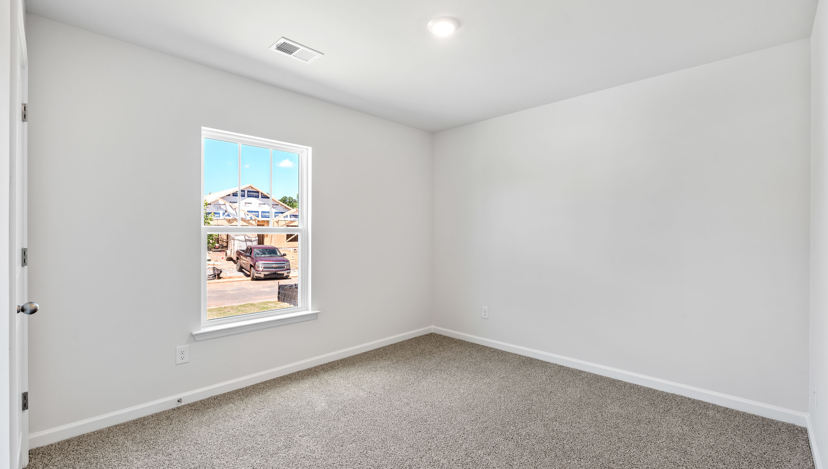 Bedroom with carpet and window.