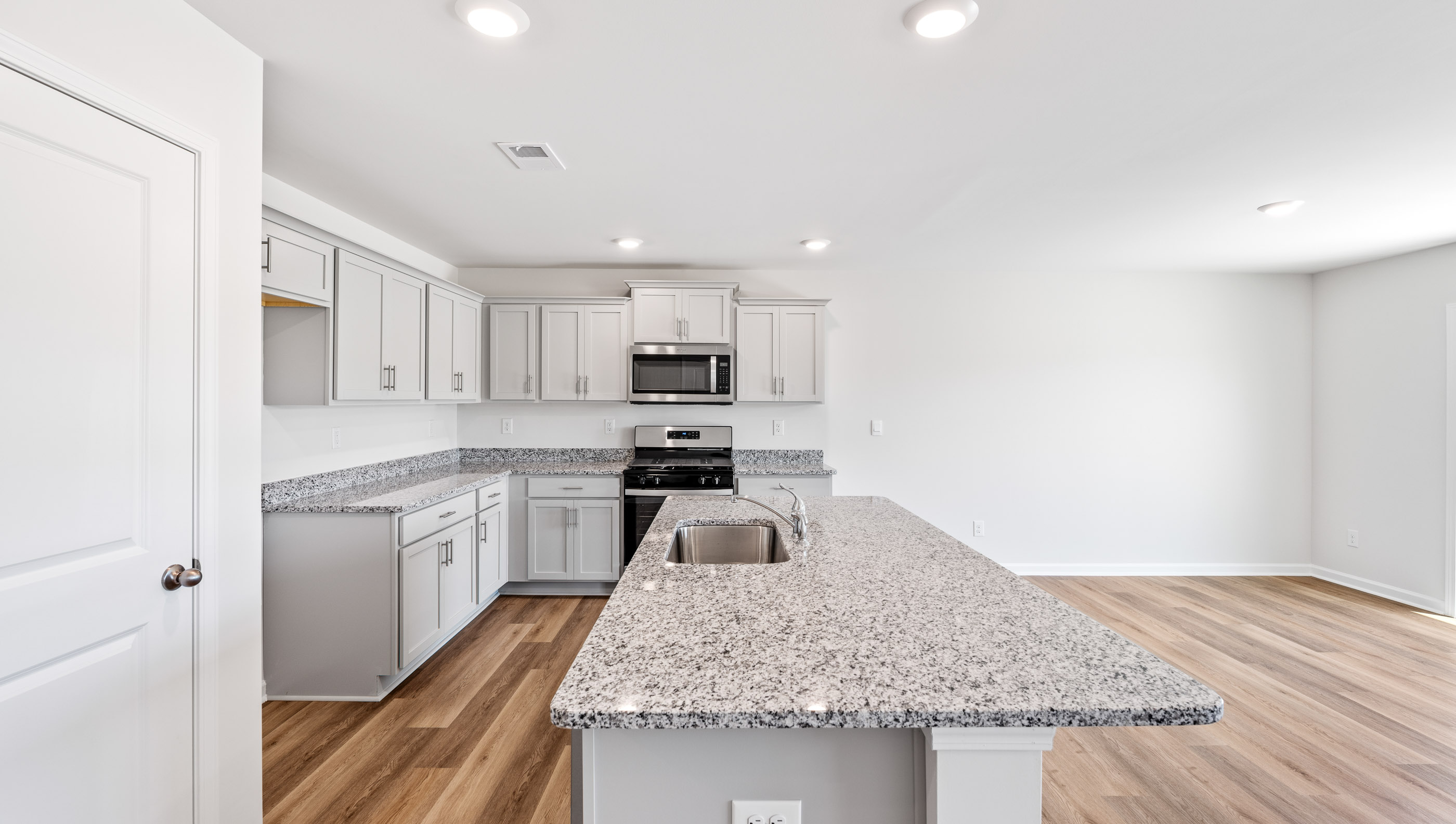 Kitchen with island and granite counter tops.
