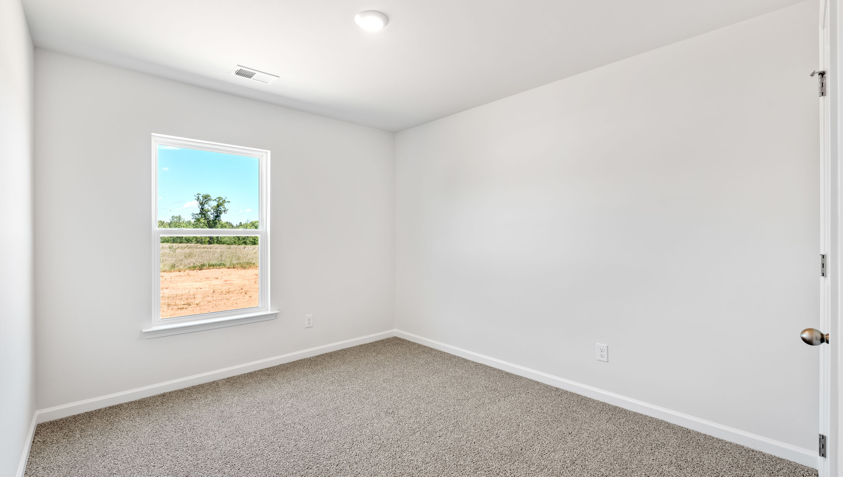 Bedroom with carpet and window.