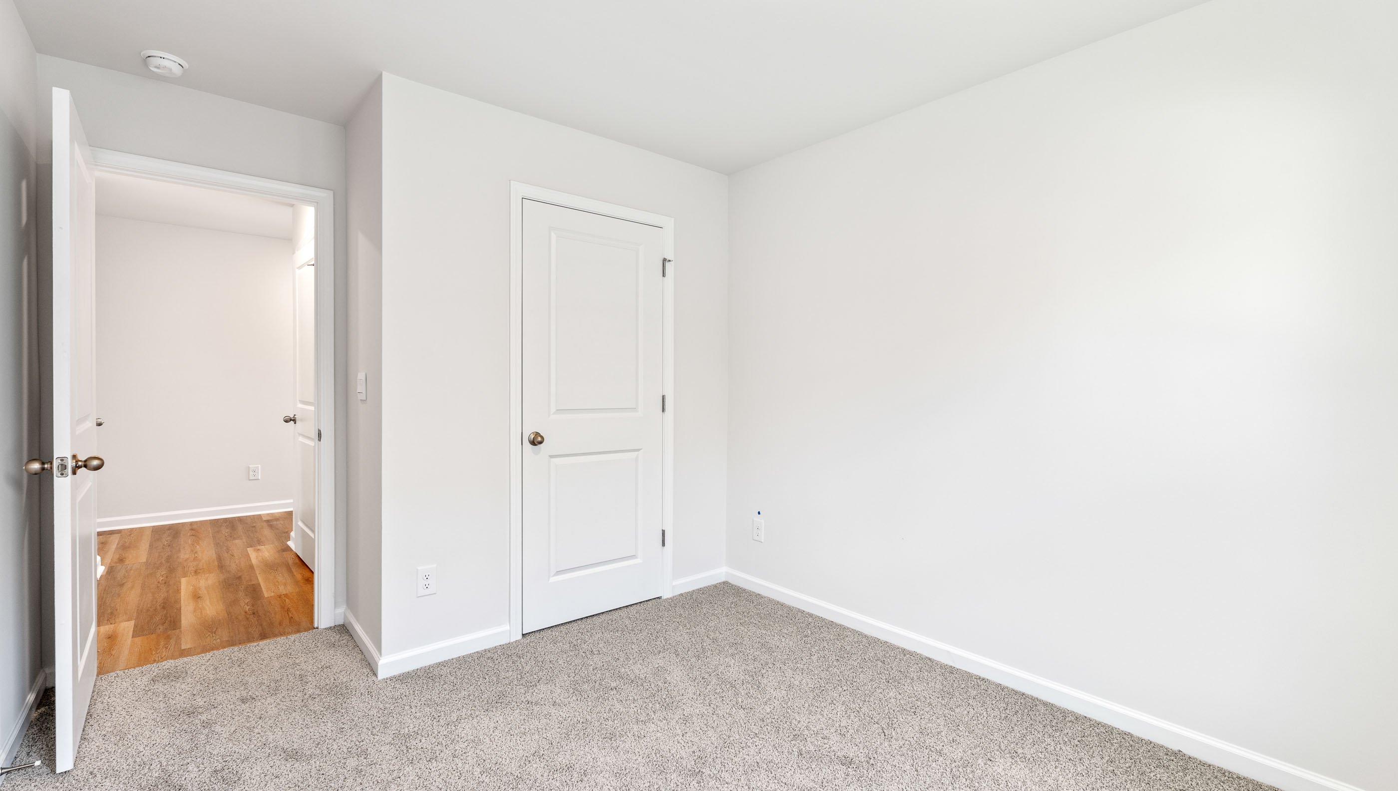 Bedroom with carpet and window.