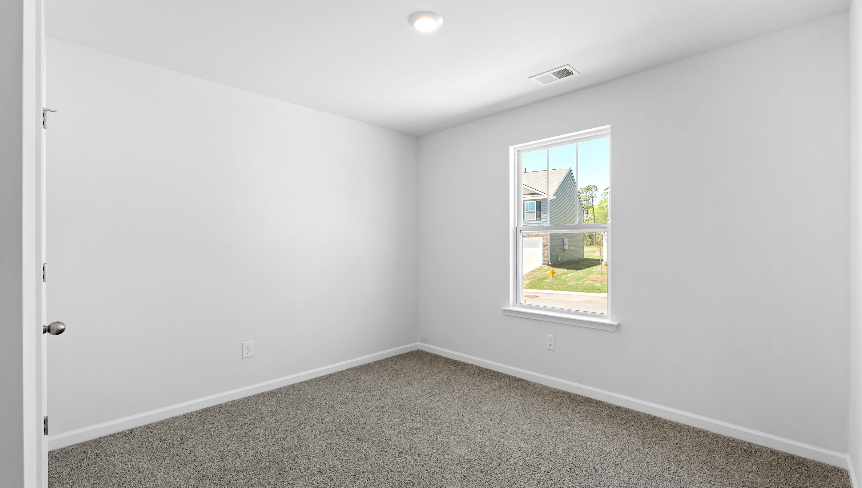 Bedroom with carpet and window.
