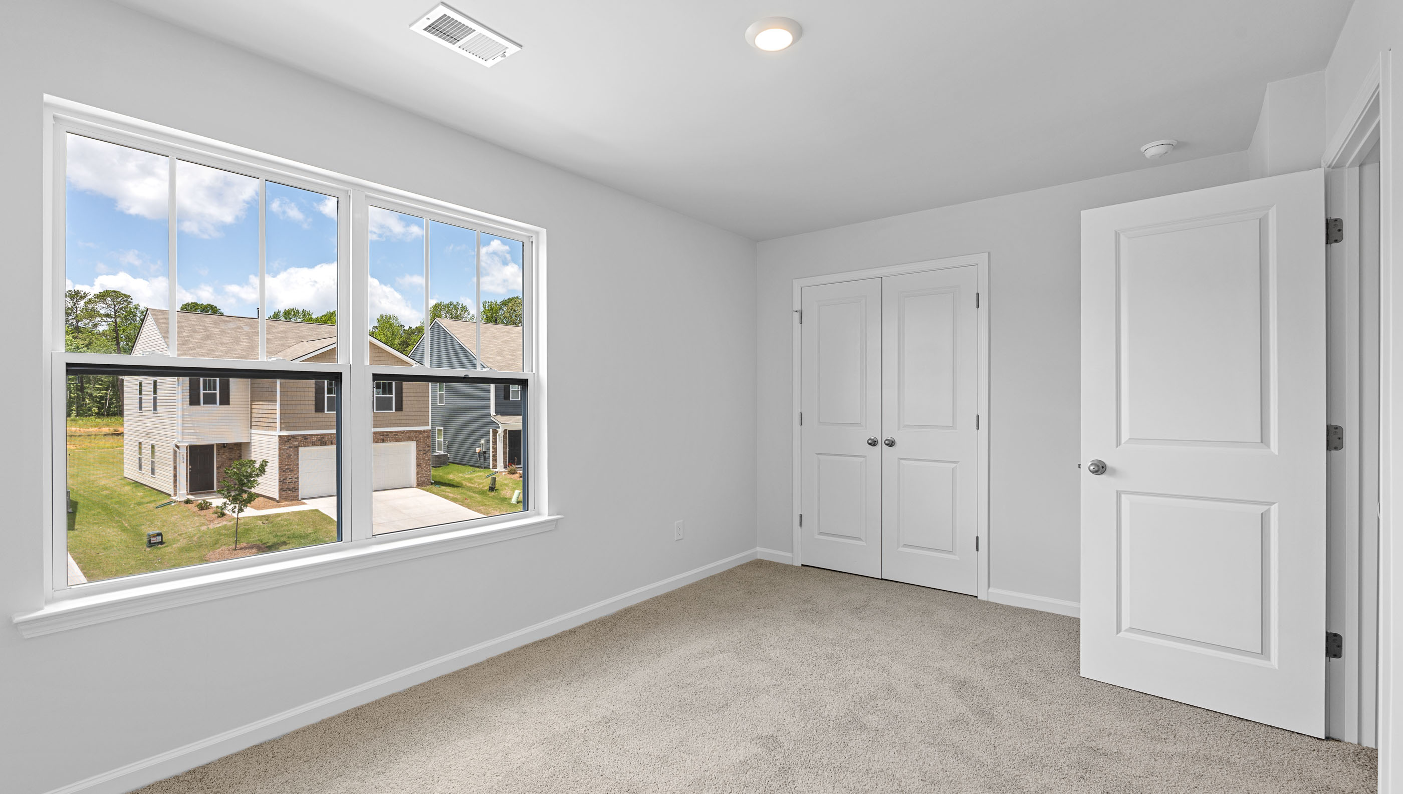 Bedroom with window and carpet.