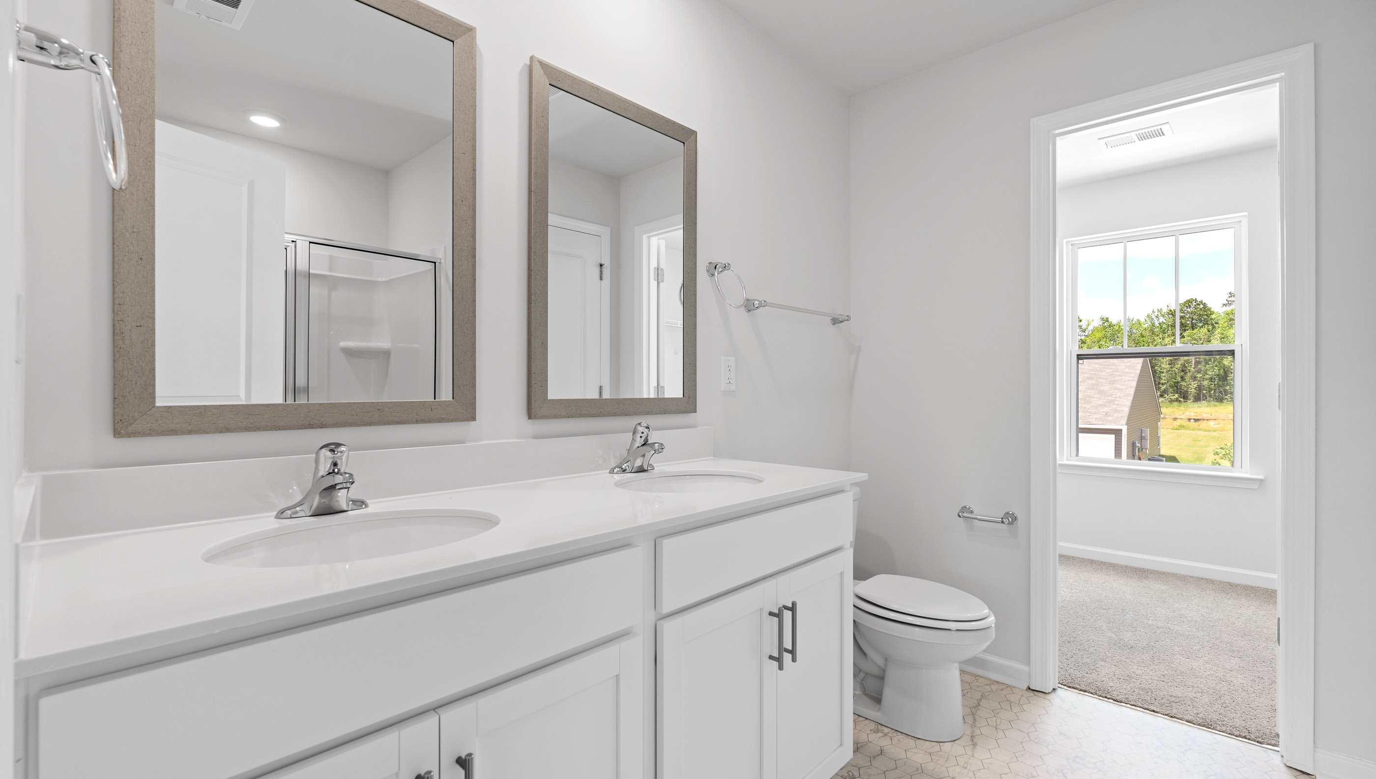 Primary bathroom with dual sink vanity.