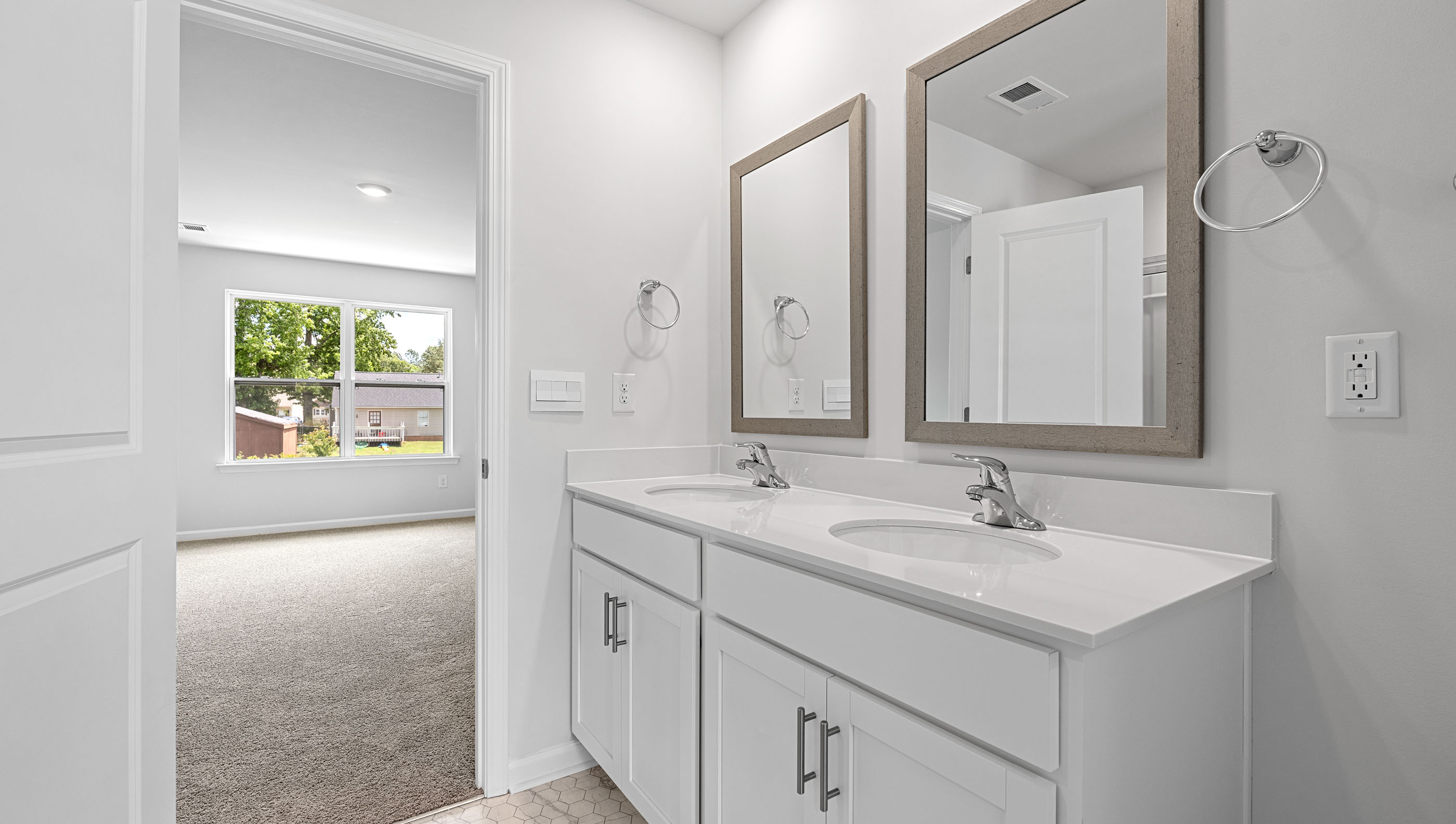Primary bathroom with dual sink vanity.