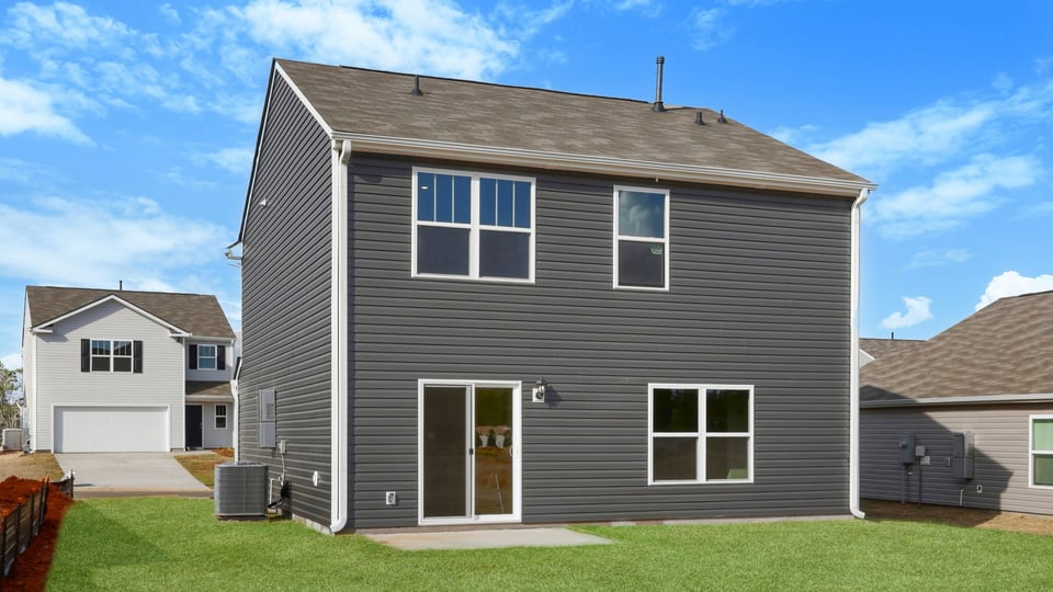 Back exterior with large backyard.