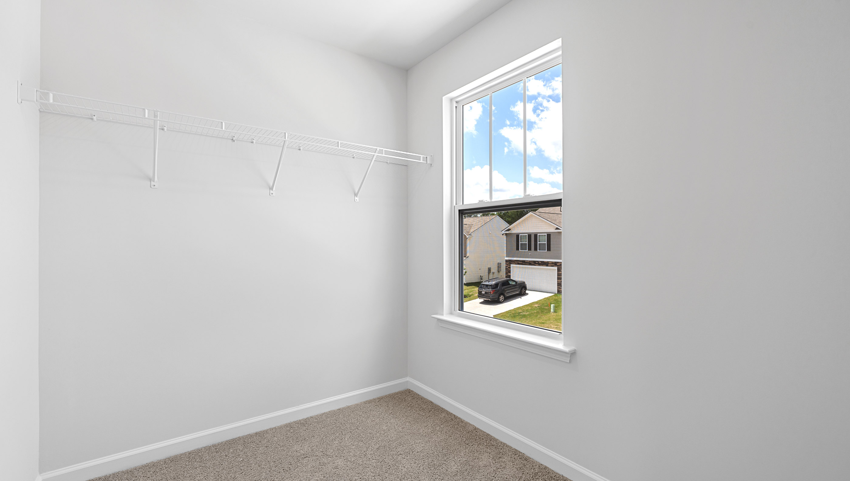 Bedroom with carpet and window