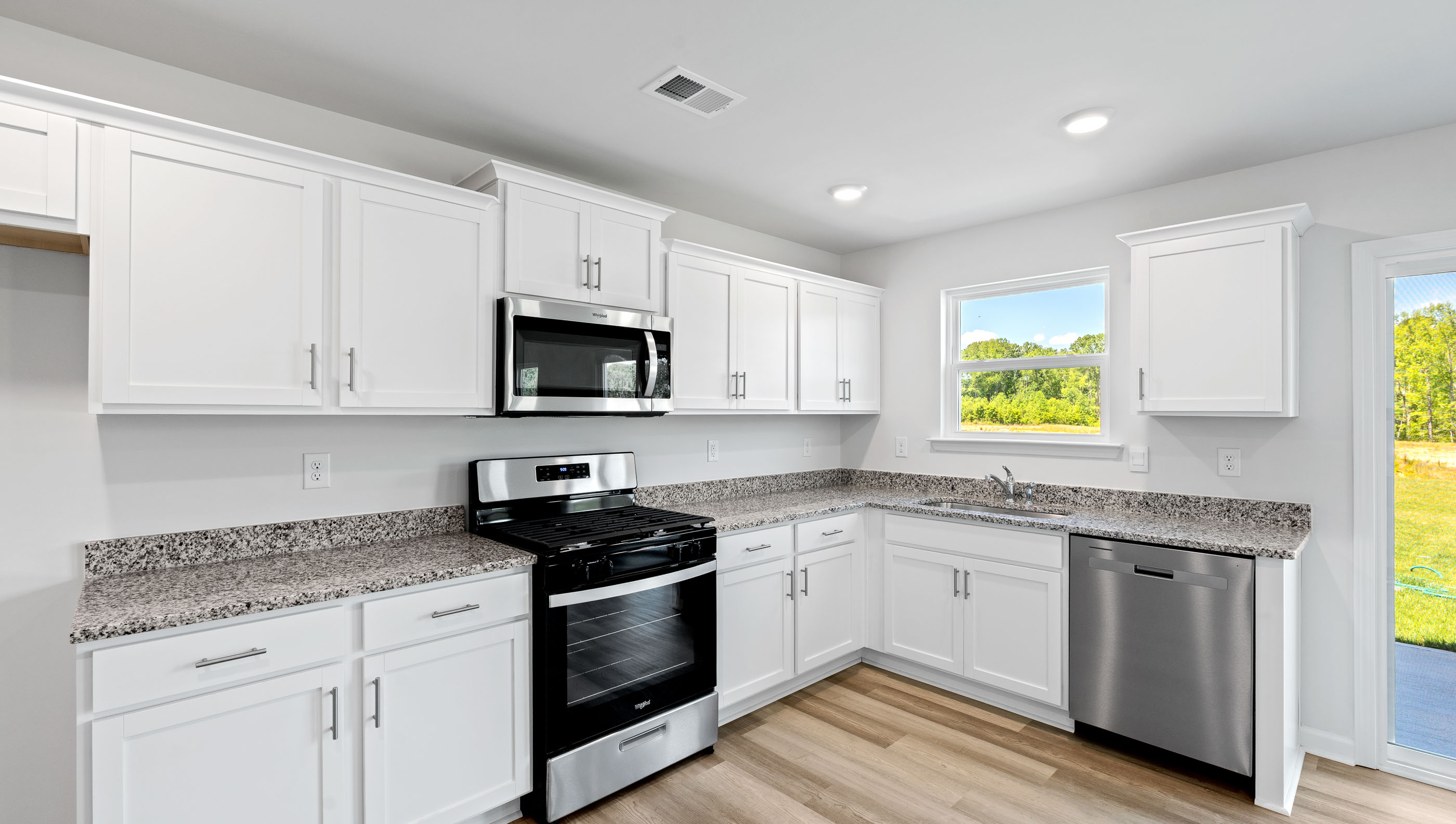 Kitchen and living area with windows.