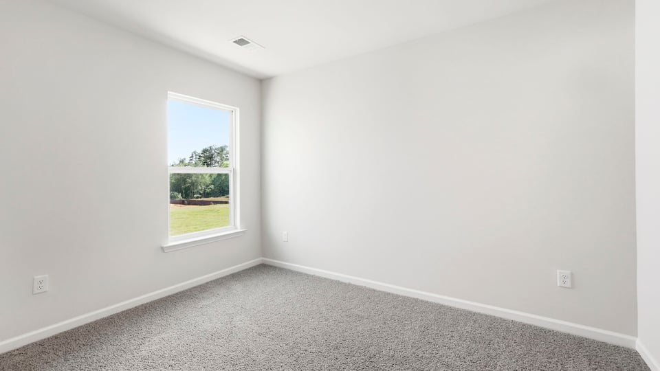 Bedroom with carpet and windows.