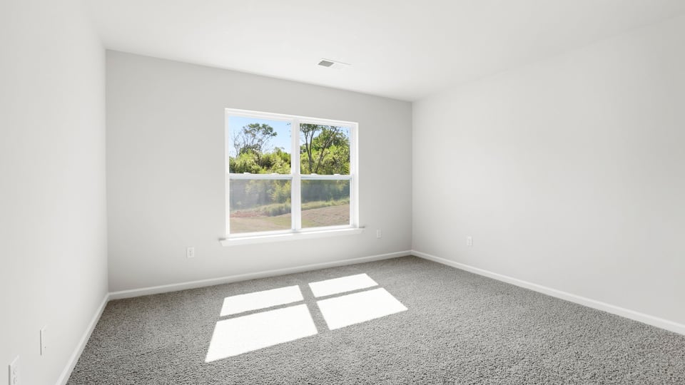 Bedroom with carpet and windows.