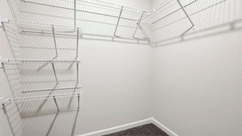 Primary closet with shelf.