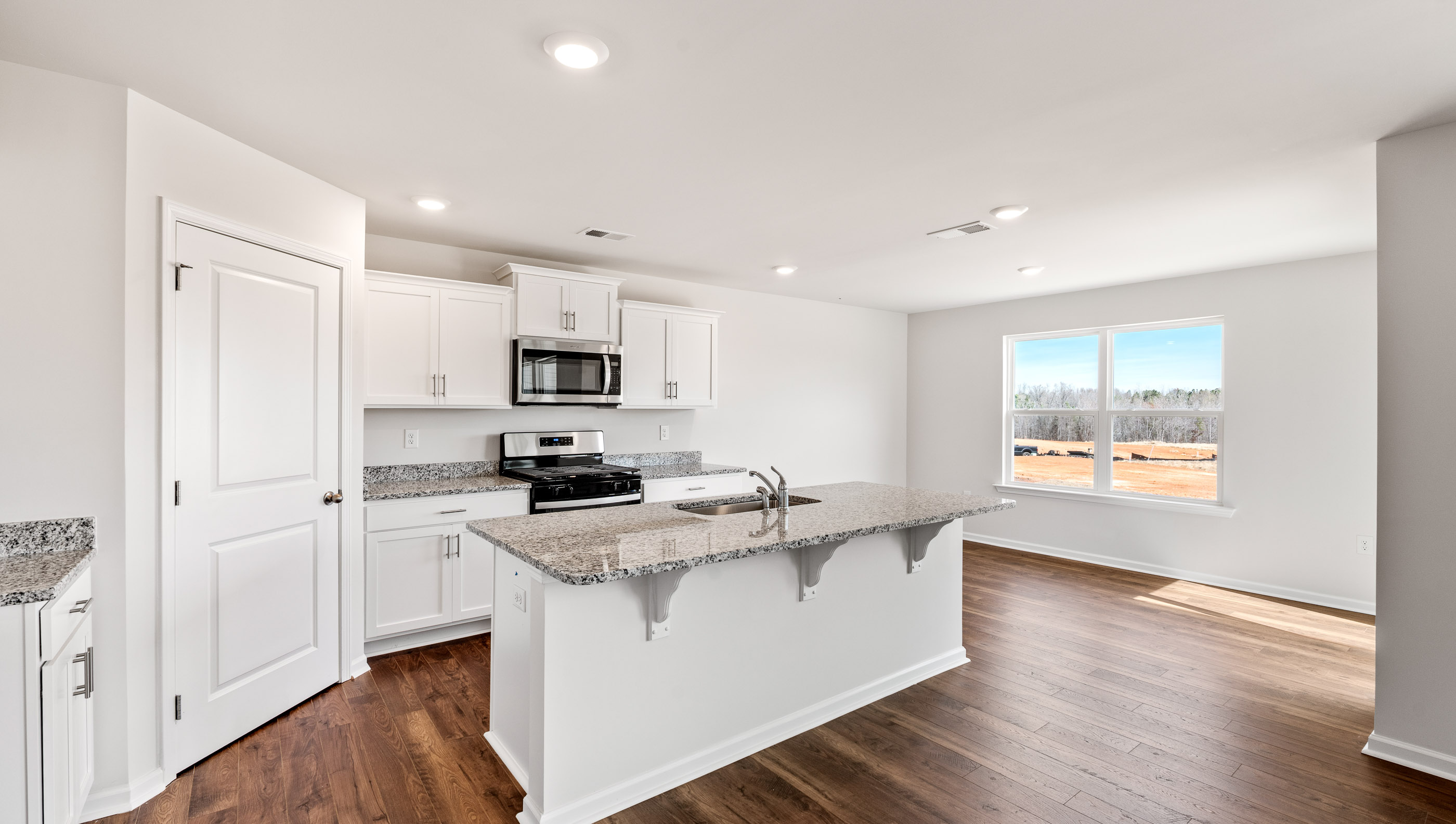 Kitchen and island with granite counter tops.