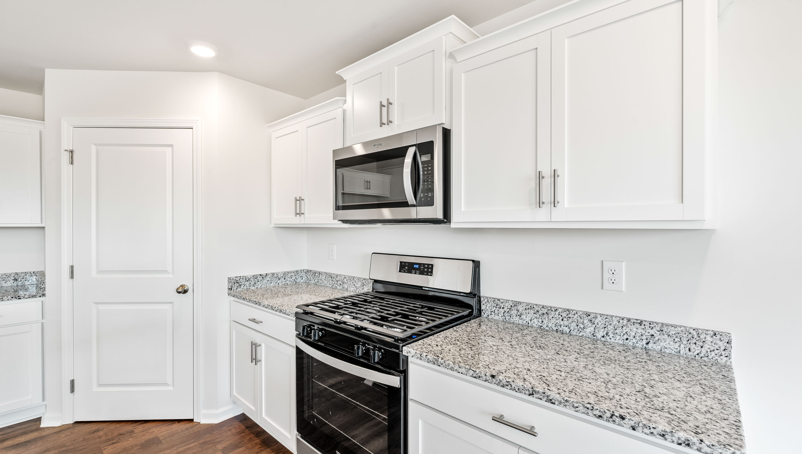 Kitchen and island with granite counter tops.