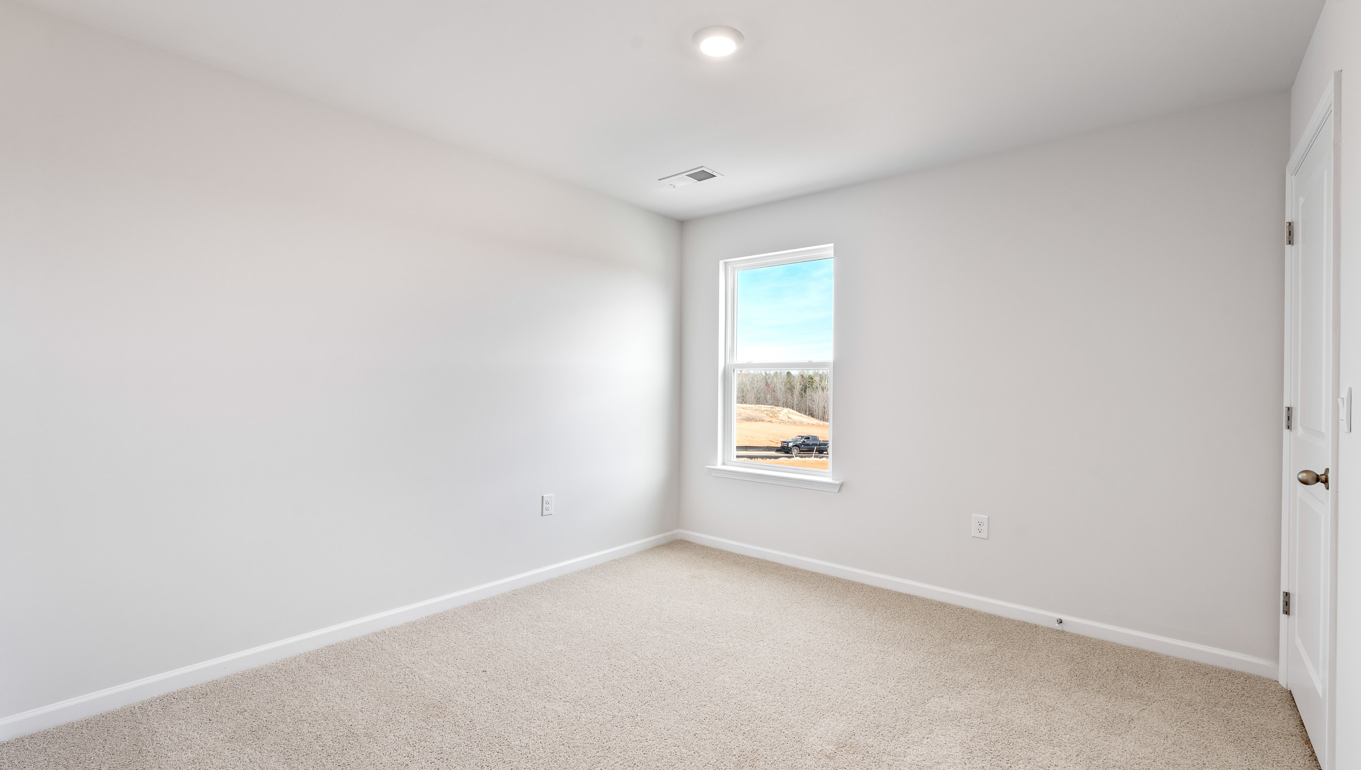 Bedroom with carpet and window.