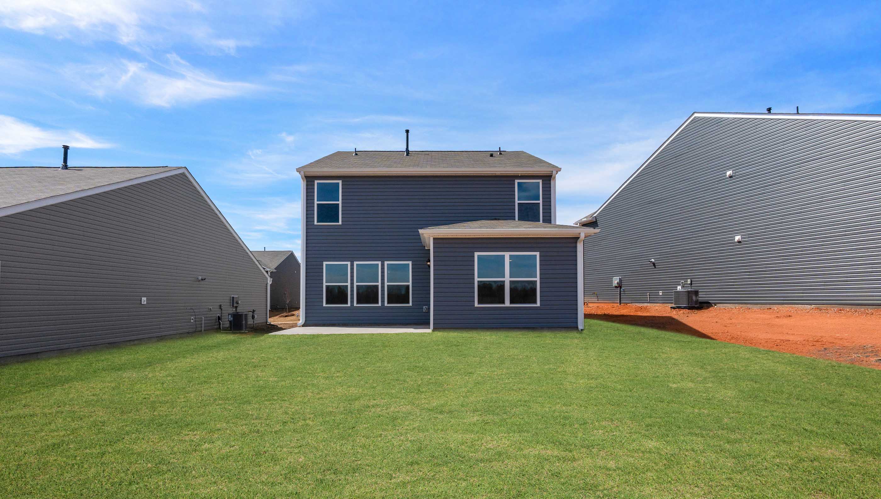 Back exterior of home with large backyard.