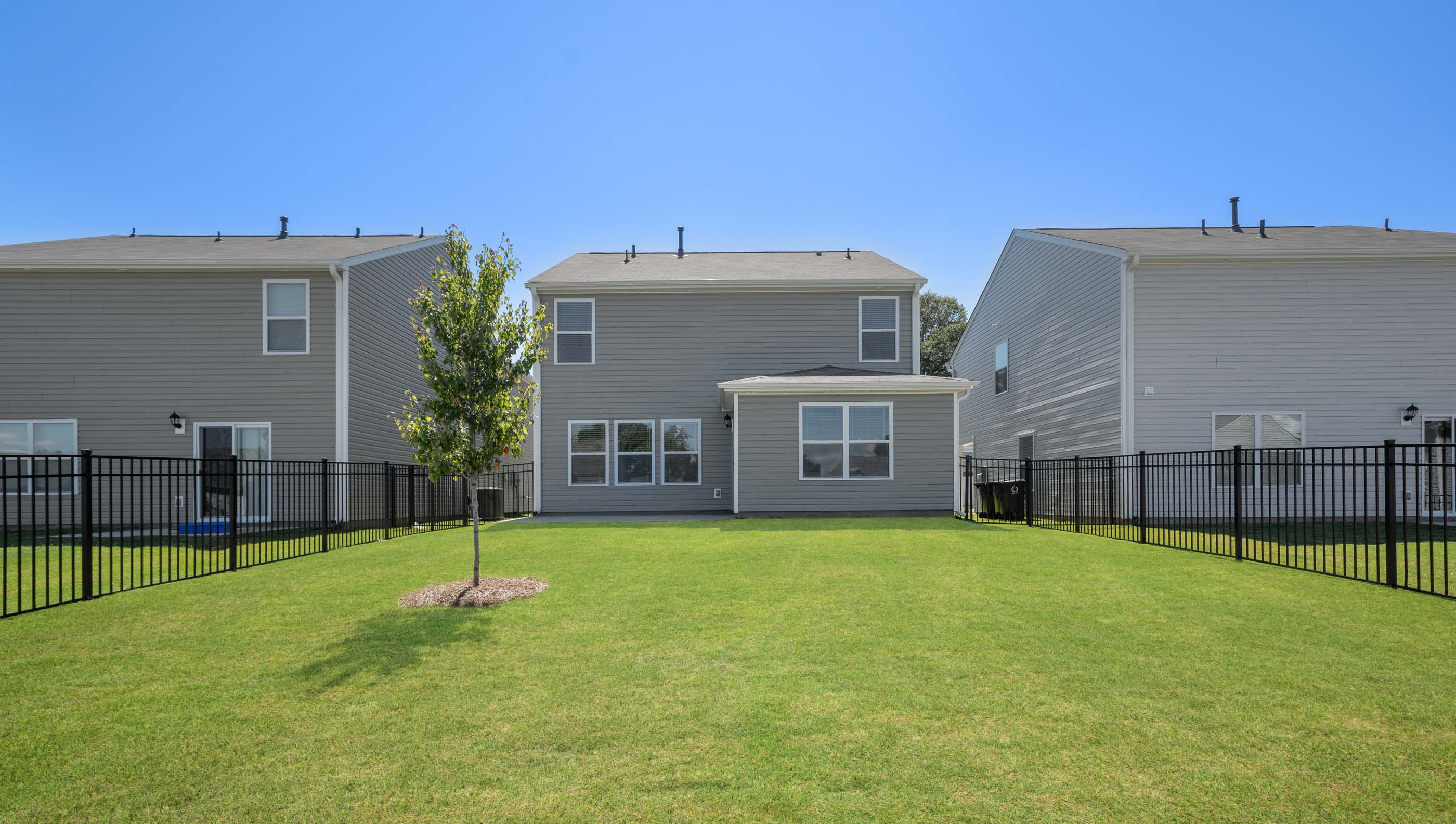 Exterior of home with large backyard.