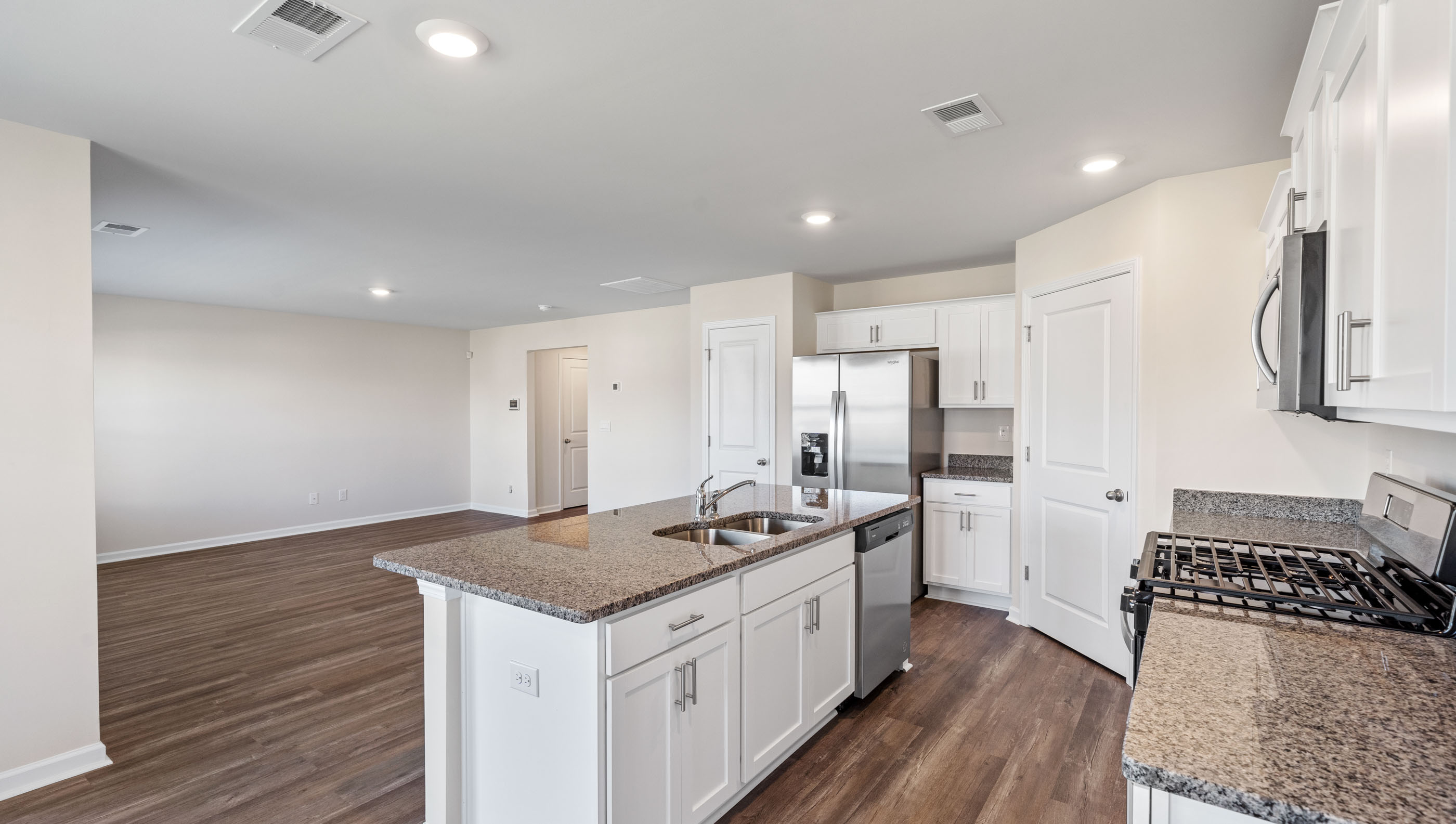 Kitchen and island with granite counter tops.