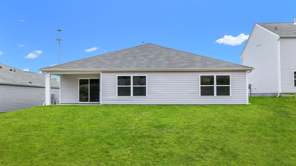 Back exterior with large backyard.