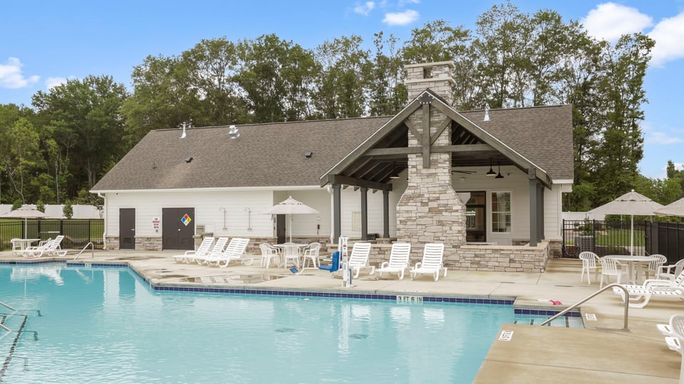 Pool amenity with chairs and umbrellas.