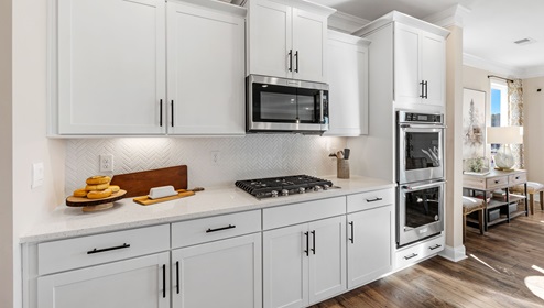 Kitchen with white cabinets and stainless steel appliances.