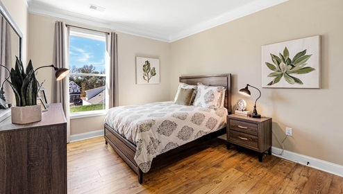 Bedroom with carpet and window.
