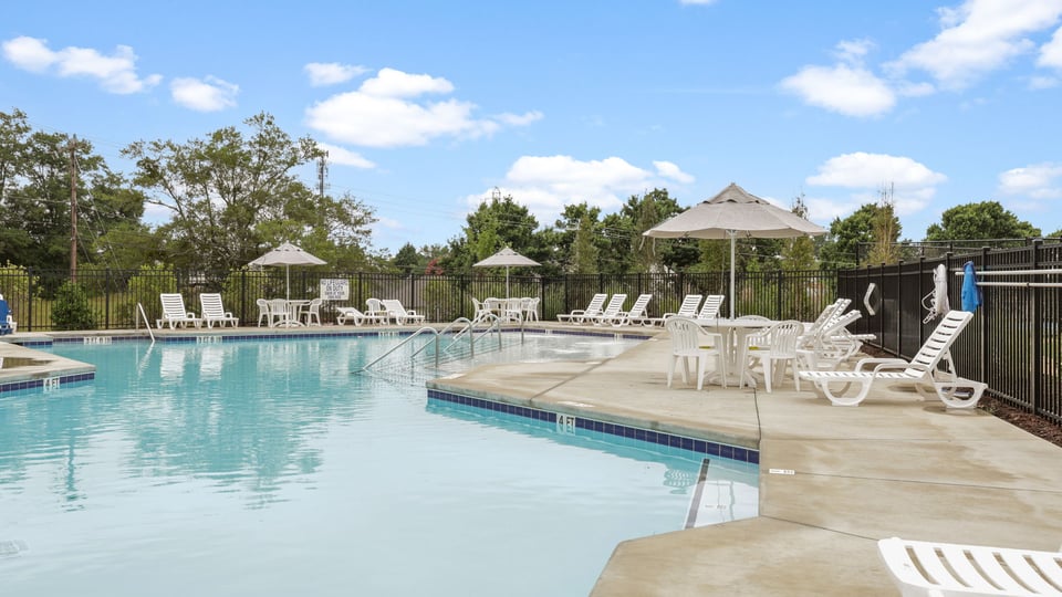 Pool amenity with chairs and umbrellas.
