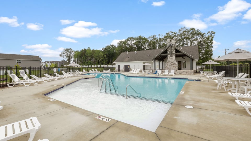 Pool amenity with chairs and umbrellas.