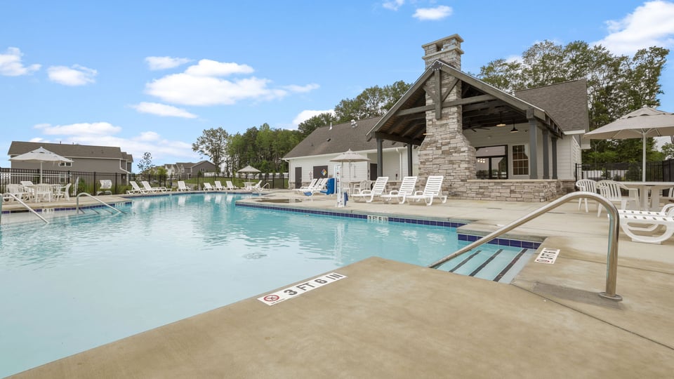 Pool amenity with chairs and umbrellas.