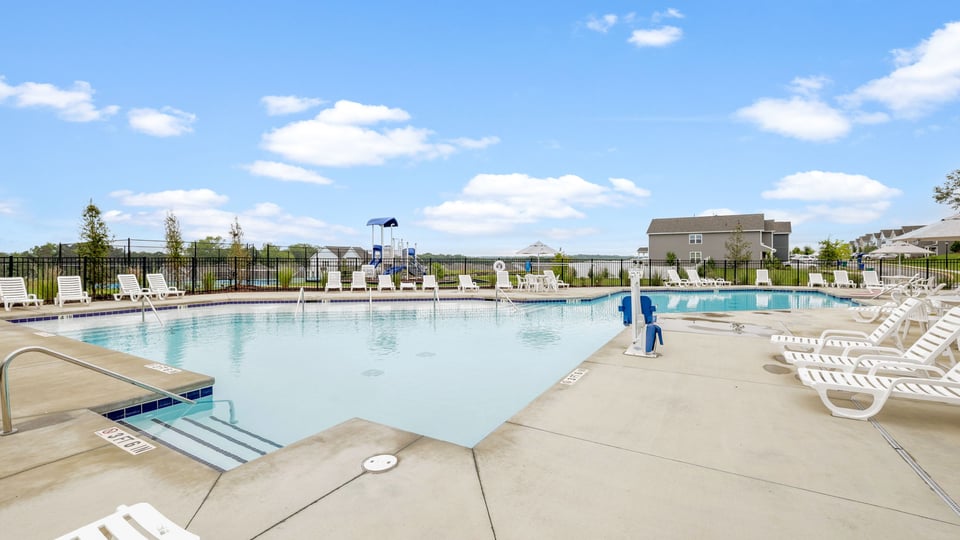 Pool amenity with chairs and umbrellas.