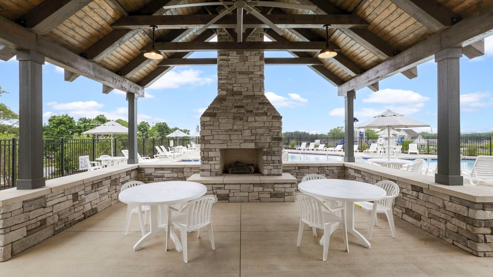 Fireplace with chairs and cabana.