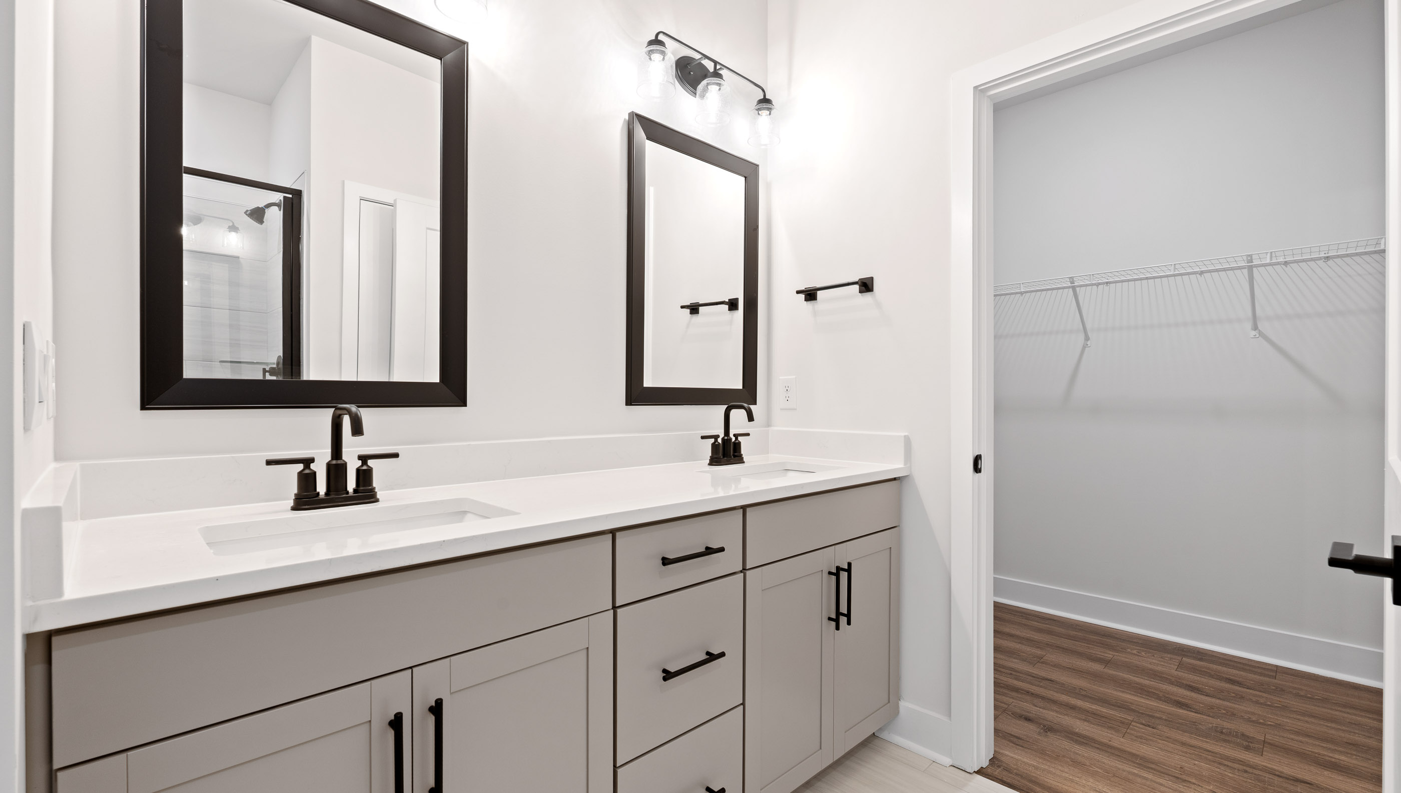 Primary bathroom with dual sink vanities.