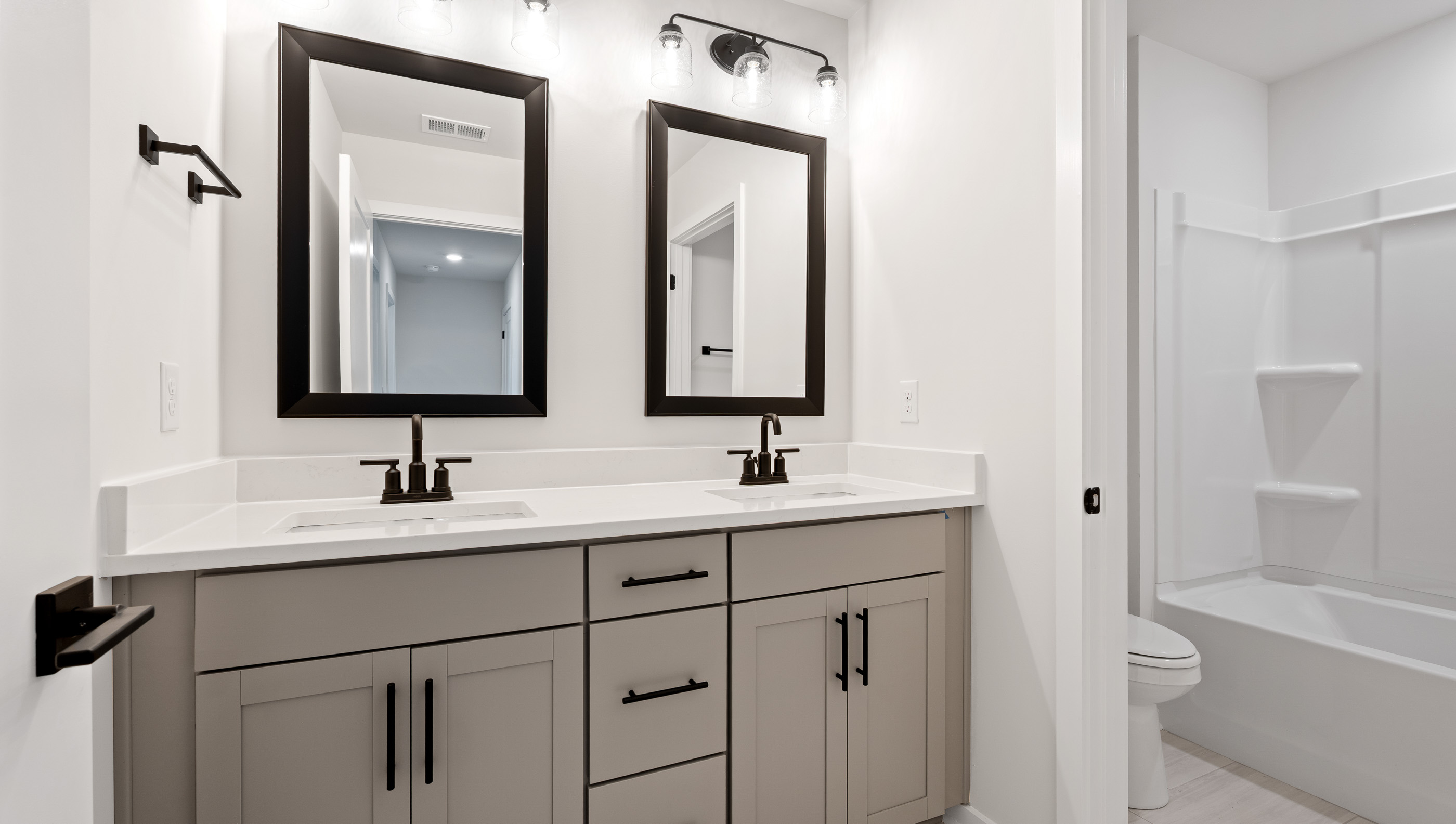 Hall bathroom with dual sink vanity.
