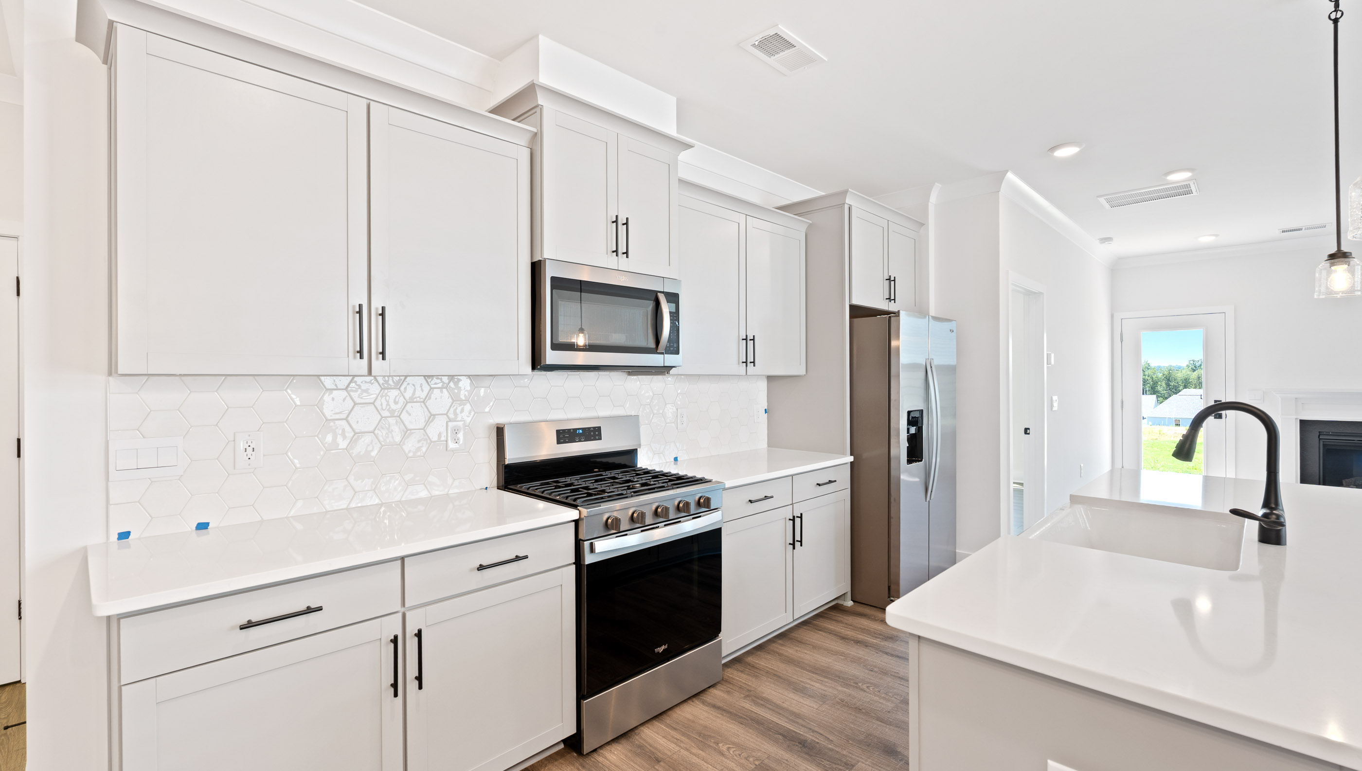 Quartz countertops and stainless steel appliances.