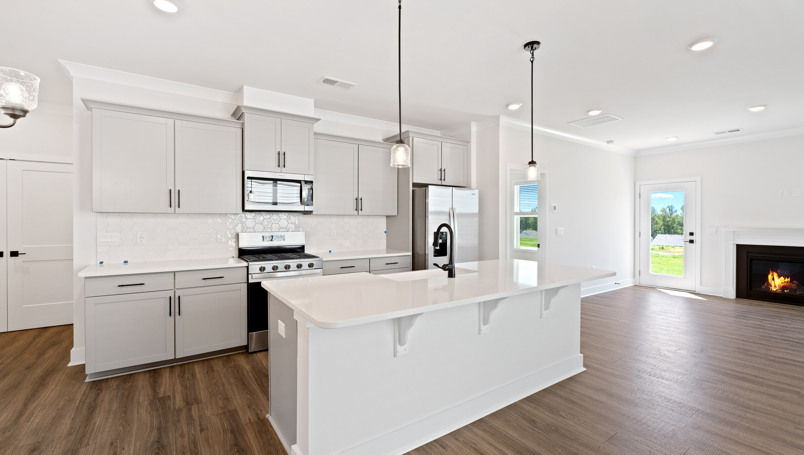 Kitchen with island and quartz countertops.
