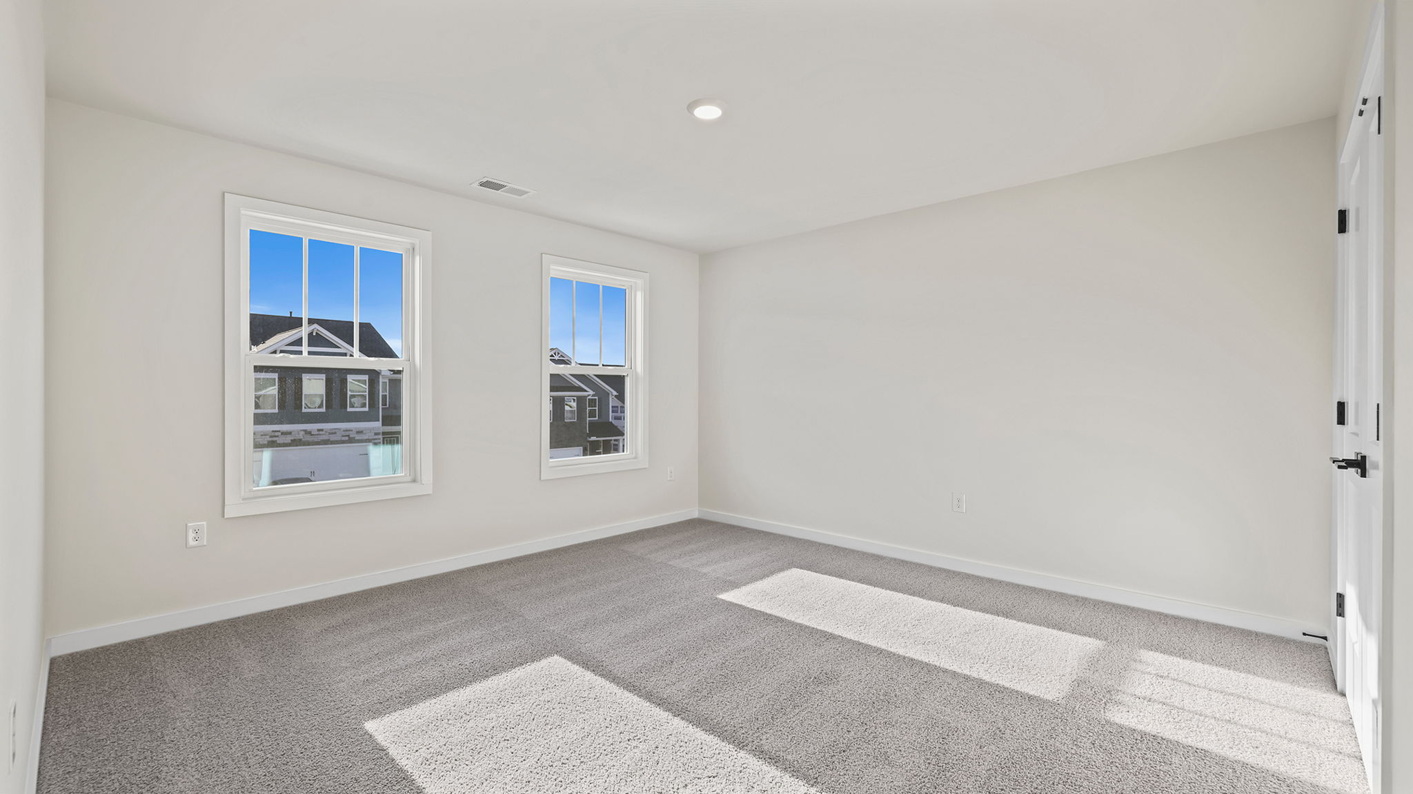 Bedroom with window and carpet.