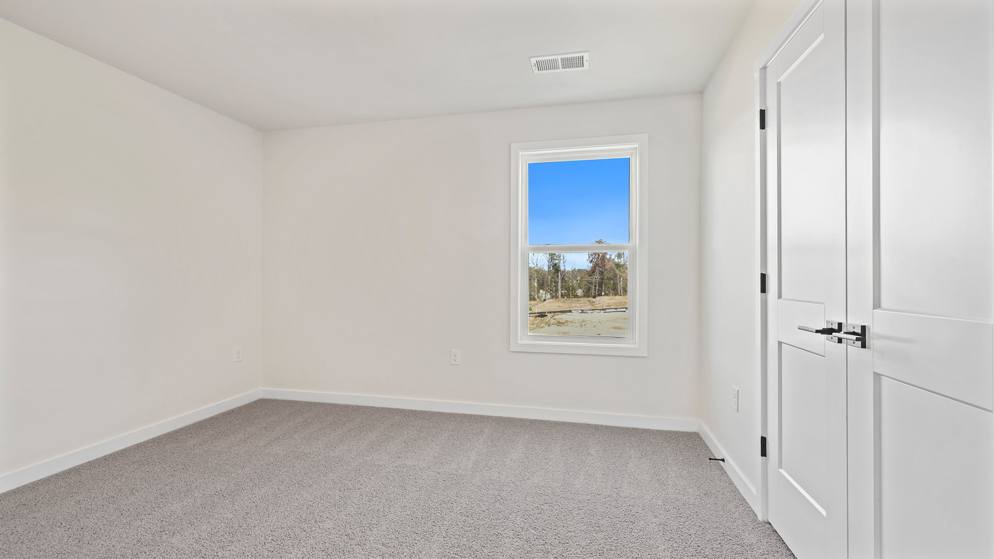 Bedroom with window and carpet.