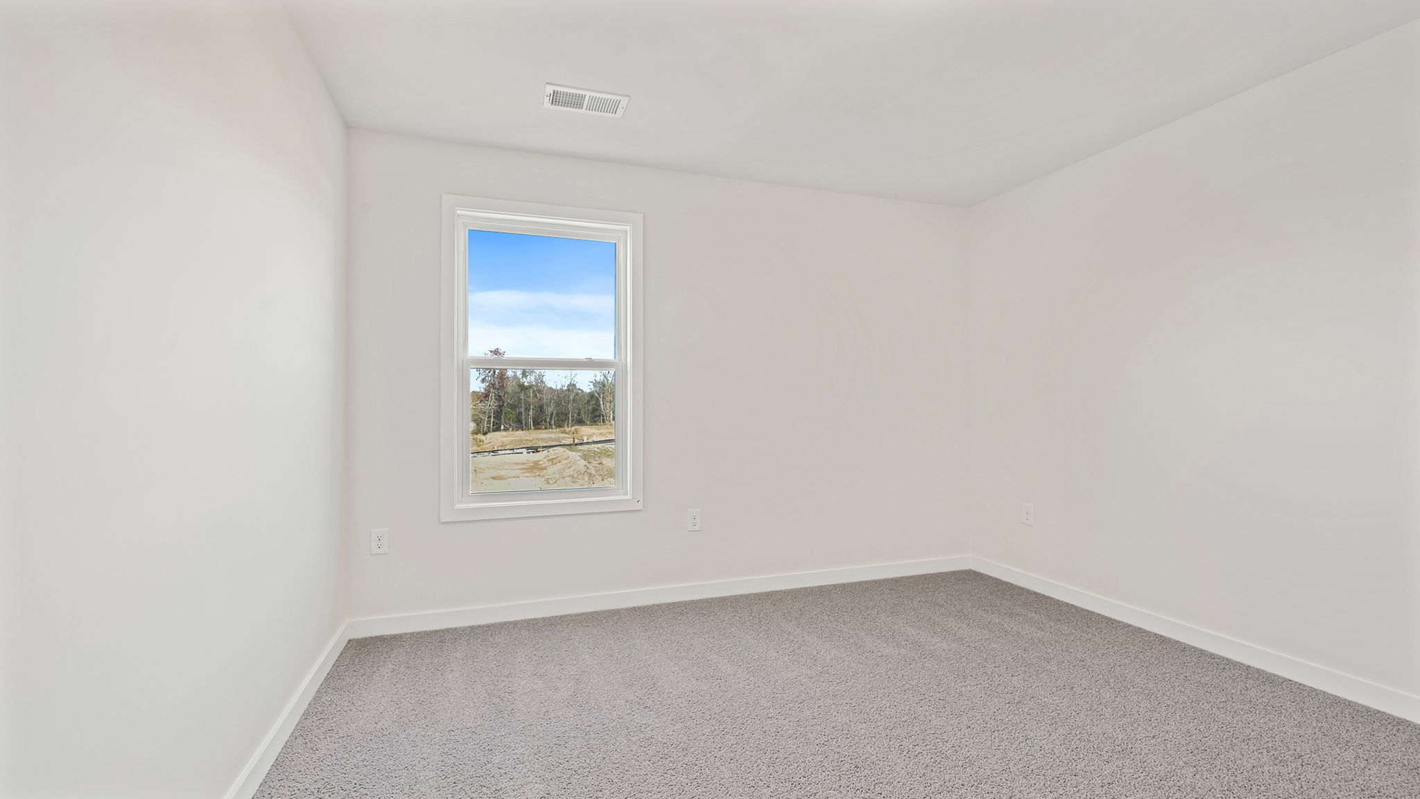 Bedroom with window and carpet.